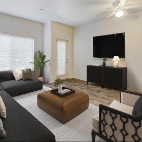 Garden-Style Apartments in Flagstaff, AZ, with In-Unit Washer and Dryer - Sterling Pointe - Living Room with Wood-Style Flooring, L-Shaped Couch, Armchair, Ottoman Served as Coffee Table, Media Cabinet, and Mounted TV.